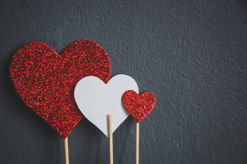 Red and white hearts isolated on grey background with copy space
