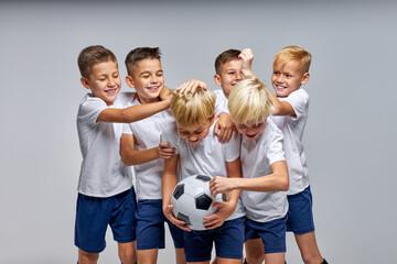 boys soccer team celebrating a victory after match, motivated children sports team have fun, laugh and celebrate