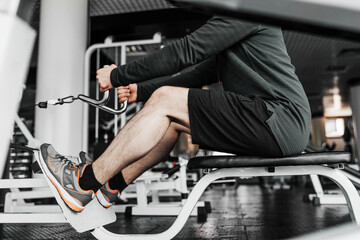 Portrait of male legs performing exercise in the gym