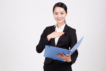 A business woman holding a blue folder