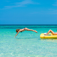 Woman diving in the beautiful turquoise caribbean waters. Negril, Jamaica