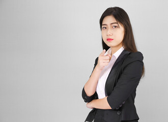 Woman in suit looking at camera and pointing finger