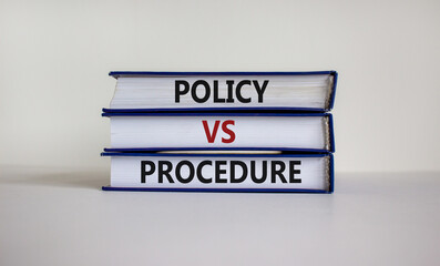Policy vs procedure symbol. Books with words 'Policy vs procedure' on beautiful white table, white...