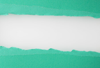 Turquoise paper is torn over white background for message. Template for your text.