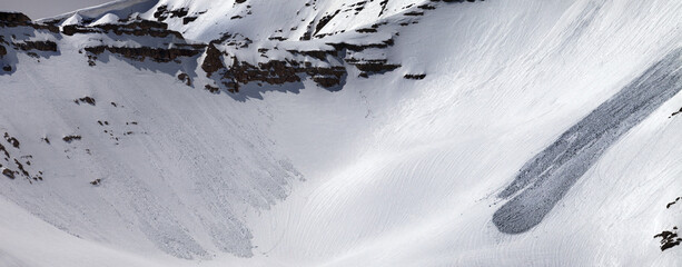 Mountains with snow cornice and traces from avalanches