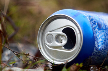 Empty blue beverage can on the grass