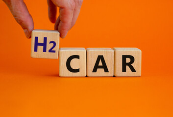 H2 hydrogen car symbol. Businesman hand holds wooden cubes with the word 'H2 hydrogen car'....