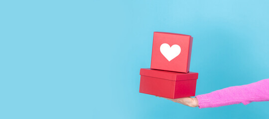 hands with gift boxes with heart isolated on background