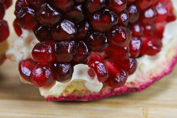 Close up of pomegranate seeds on one part of the pomegranate where there is pomegranate peel. Macro...