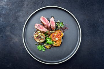 Modern style traditional wild hare back filet braised with tomato slices and capers in herb jus...