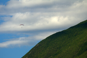 paragliding in the mountains,blue, fly, paraglider,sport, nature, flying, clouds, air, extreme, freedom,flight, mountain, landscape, high, adventure, activity,