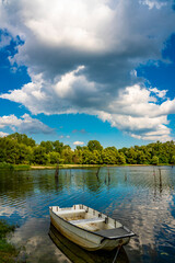 Naklejka premium Small boat on the calm lake
