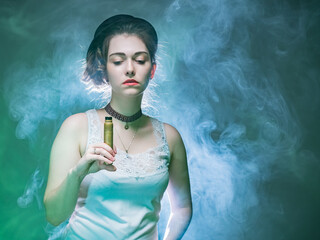 The girl with the VAPE is illuminated from behind. The woman holds a VAPE in her hand and looks...