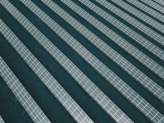 Aerial view of a solar farm producing clean renewable sun energy, industrial landscape