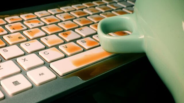 coffe spilled on a computer keyboard close-up