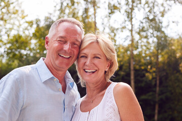 Portrait Of Loving Senior Couple In Garden At Home Together