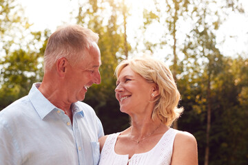 Obraz premium Portrait Of Loving Senior Couple In Garden At Home Together