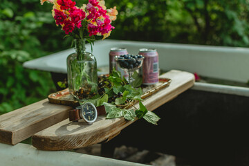 Men's wrist watch standing on the wood shelf with flowers