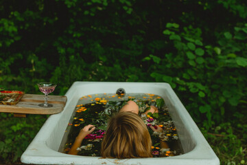 Woman sitting in outdoor flower bath