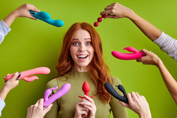 woman and a lot of sex toys near her, a huge selection on the market, she is pleasantly surprised,...