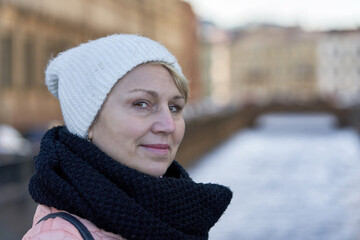 Portrait of a middle aged woman in a scarf and hat