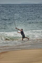 Fisherman at Ponta Negra beach, Rio de Janeiro, Brazil