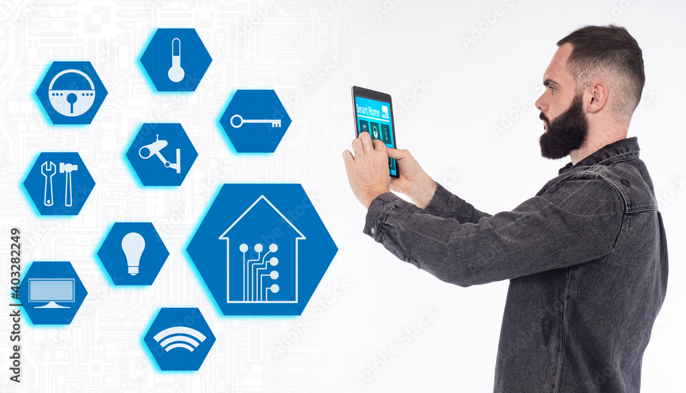 Poster a man remotely controls the systems of his home. a man uses the smart home app on his tablet. the io