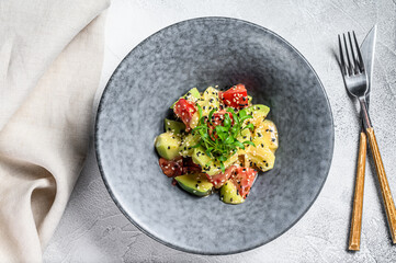 Avocado, tomato and arugula salad. Healthy vegan food. White background. Top view