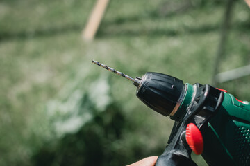 Man holding a drill in garden