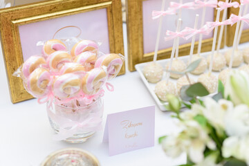 Twisted mini lollipops and cake pops on a wedding candy bar