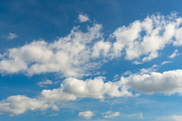 Naklejka na ściany i meble Cirrus and cumulus clouds on blue sky background.
