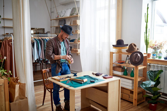 male goldsmith at work place, making jewelry alone, repairing for sale. handicraft, craftsman