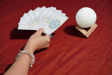 Tarot card reading on cloth for fate or fortune telling through design card. Gypsy paranormal in...