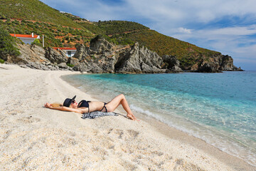 Young woman at the beach Kalamos in Evia island, Greece