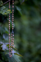 rosary with wooden beads and metal medallion
