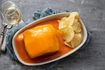 typical Portuguese food Francesinha with fried chips in dish