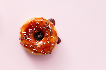 one donut with jam on pink background