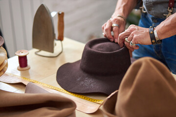 the process of making hats for customer, maintenance and crafting sewing clothes concept. designer...