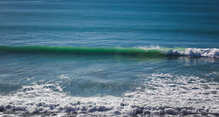 Beautiful landscape, wave rising on the surface of the blue ocean
