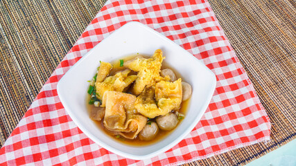 bowl of Bakso Cuanki, typical food from West Java, Indonesia - served on white bowl with napkin