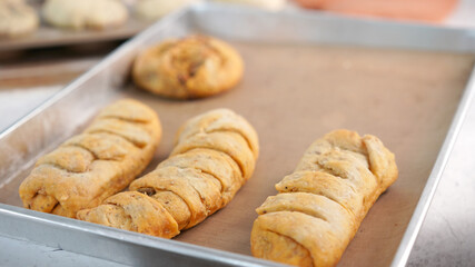 Whole wheat bread from homemade whole grain dough made by woman with red apron. Healthy pastry with many grains.