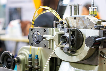 Oil coolant or lubricant flow out of hole discharge gate of wire feeder unit continuous high...