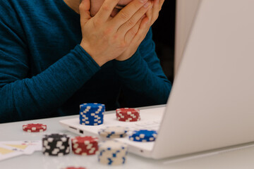 young man playing with his computer on gambling websites. online casino poker roulette. Lifestyle. Winner or bankrupt by becoming a millionaire.