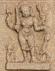 Hampi, Karnataka, India - November 4, 2013: Hazara Rama Temple. Closeup of beige stone sculptures of Lord Vishnu with monkeys at his feet.