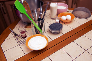 Items and products for making a cake on the table.