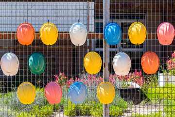 Helmets hanging on a fence in Coober Pedy, Australia