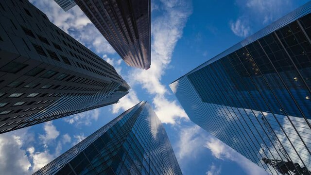Business and finance concept, time lapse view looking up at modern office building architecture in the financial district of Toronto in Ontario, Canada.