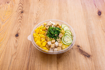 vegan poke bowl on wooden table