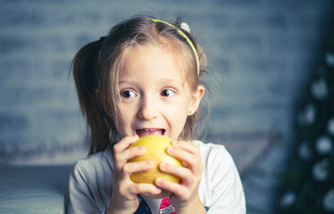 image of a little beautiful girl who is going to eat an apple