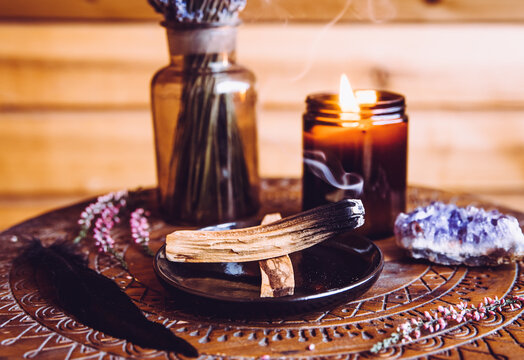 Palo Santo Wood Known As Oily Aromatic Holy Wood Sticks Smouldering On Plate In Home Living Room Cleansing Negative Energy Concept. Bohemian Style Cottage Home Decor.